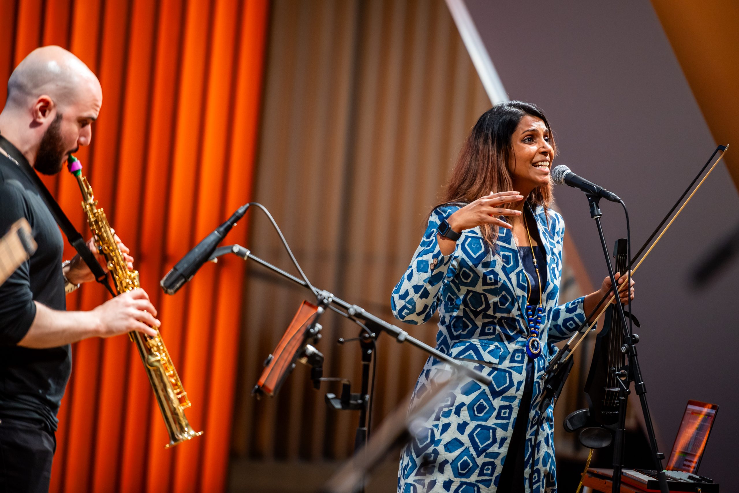 Memory Futures: Desi Transcendence Musician Rini singing in front of her band